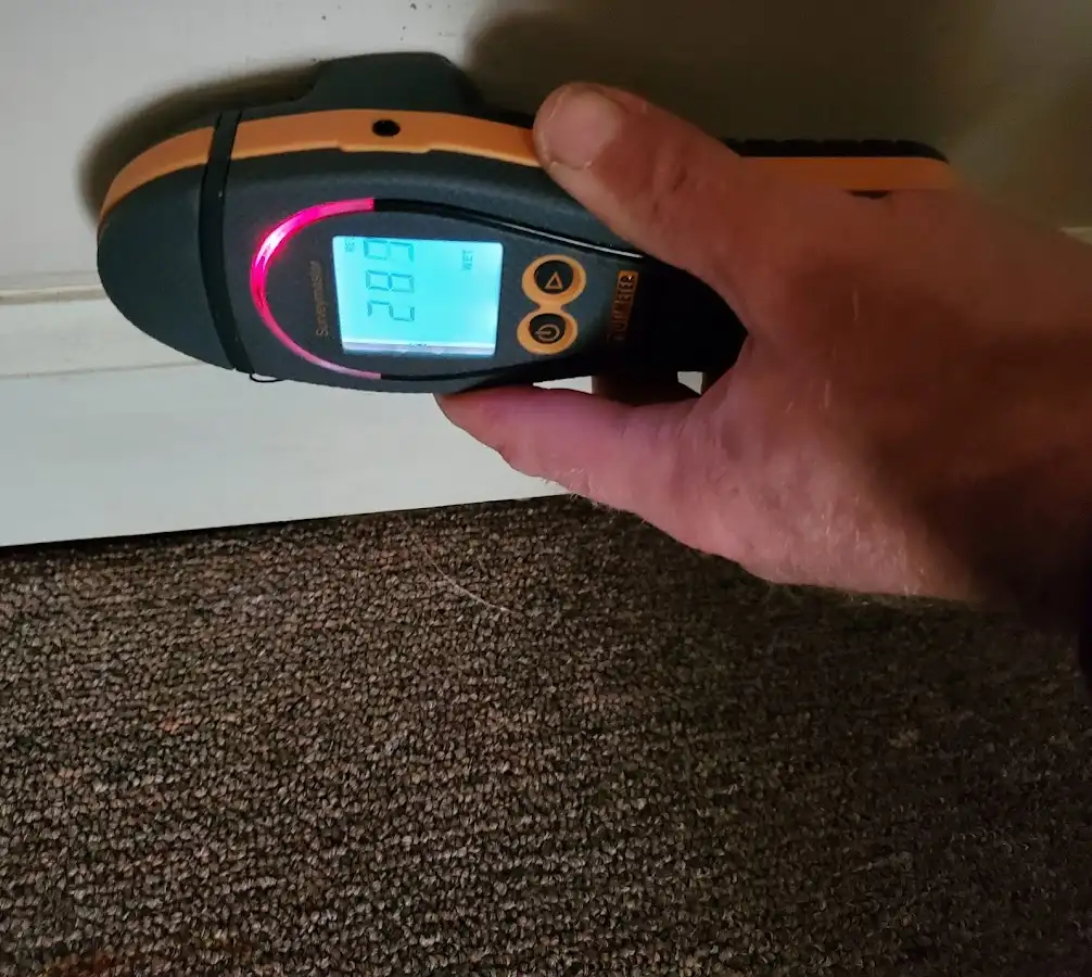 Moisture detection at baseboard during Storm Damage Restoration in Edgewood